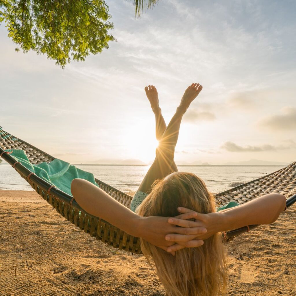 woman lying in hammock on beach